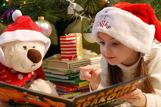 Christmas traditions, girl reading a Christmas book