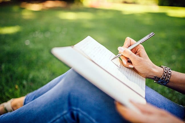 how to practice gratitude, person writing in notebook